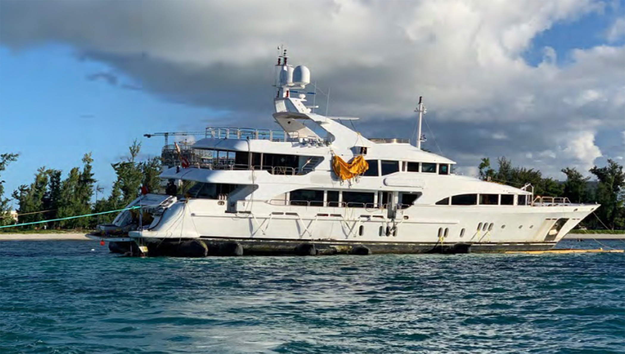 Yacht with yellow sheet hanging from top deck